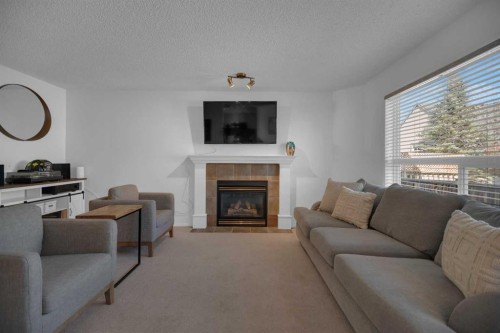 154 Bridlewood Court Sw, Calgary, AB - Indoor Photo Showing Living Room With Fireplace