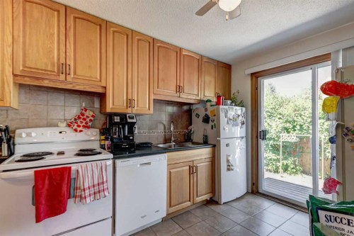 202 Olympia Drive Se, Calgary, AB - Indoor Photo Showing Kitchen With Double Sink