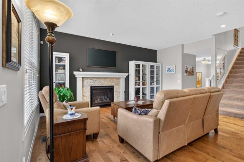 172 Riviera Way, Cochrane, AB - Indoor Photo Showing Living Room With Fireplace