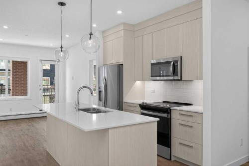 3201-6 Merganser Drive West, Chestermere, AB - Indoor Photo Showing Kitchen With Double Sink With Upgraded Kitchen