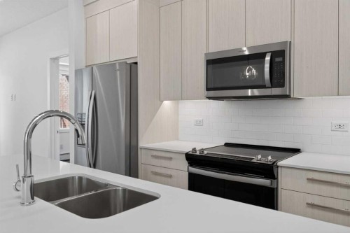 3201-6 Merganser Drive West, Chestermere, AB - Indoor Photo Showing Kitchen With Stainless Steel Kitchen With Double Sink With Upgraded Kitchen