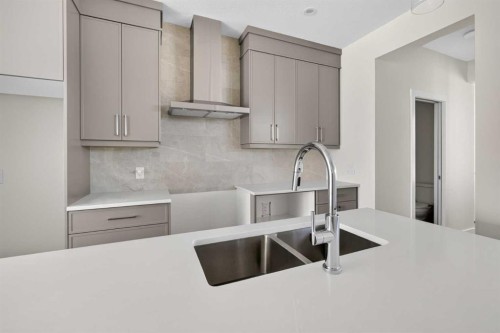 138 Starling Boulevard Nw, Calgary, AB - Indoor Photo Showing Kitchen With Double Sink With Upgraded Kitchen