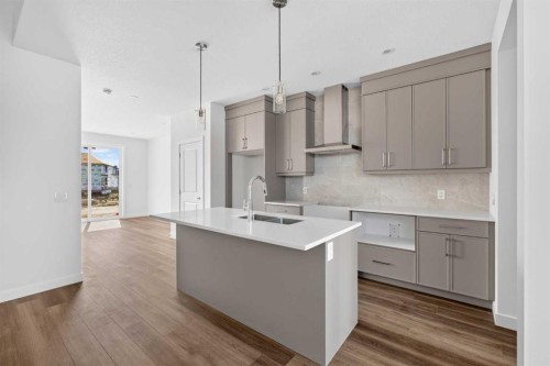 138 Starling Boulevard Nw, Calgary, AB - Indoor Photo Showing Kitchen With Double Sink With Upgraded Kitchen
