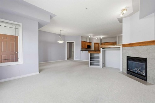 113-60 Sierra Morena Landing Sw, Calgary, AB - Indoor Photo Showing Living Room With Fireplace