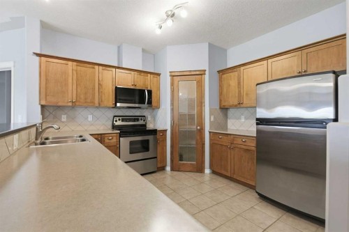 113-60 Sierra Morena Landing Sw, Calgary, AB - Indoor Photo Showing Kitchen With Double Sink