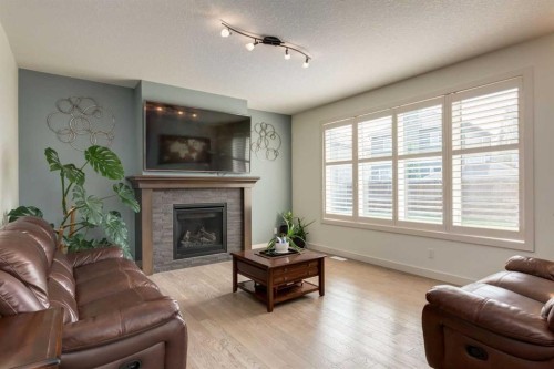 439 Canals Boulevard Sw, Airdrie, AB - Indoor Photo Showing Living Room With Fireplace