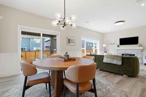 711 Mandalay Link, Carstairs, AB - Indoor Photo Showing Dining Room With Fireplace