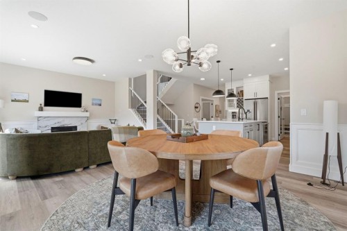 711 Mandalay Link, Carstairs, AB - Indoor Photo Showing Dining Room With Fireplace