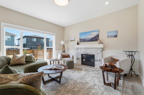 711 Mandalay Link, Carstairs, AB - Indoor Photo Showing Living Room With Fireplace