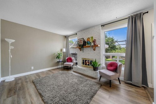 44 Strathclair Rise Sw, Calgary, AB - Indoor Photo Showing Living Room With Fireplace