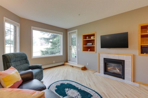 3109-3109 Hawksbrow Point Nw, Calgary, AB - Indoor Photo Showing Living Room With Fireplace