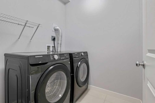 22 West Coach Manor Sw, Calgary, AB - Indoor Photo Showing Laundry Room