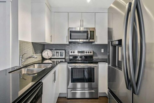 22 West Coach Manor Sw, Calgary, AB - Indoor Photo Showing Kitchen With Stainless Steel Kitchen With Double Sink With Upgraded Kitchen