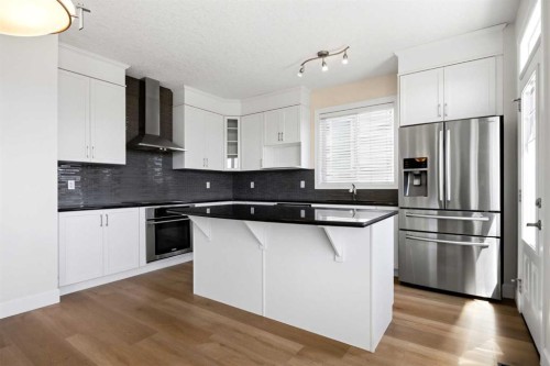 596 Windbrook Heights, Airdrie, AB - Indoor Photo Showing Kitchen With Upgraded Kitchen