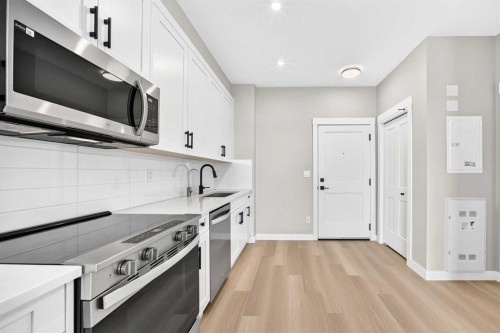 1409-3700 Seton Avenue Se, Calgary, AB - Indoor Photo Showing Kitchen With Upgraded Kitchen