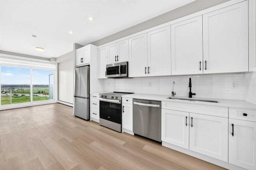 1409-3700 Seton Avenue Se, Calgary, AB - Indoor Photo Showing Kitchen With Upgraded Kitchen