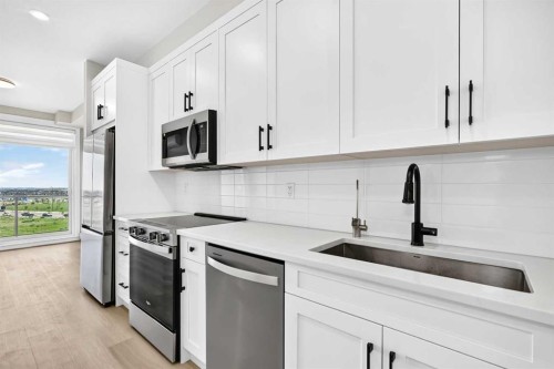 1409-3700 Seton Avenue Se, Calgary, AB - Indoor Photo Showing Kitchen With Upgraded Kitchen
