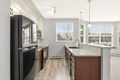 137-1 Crystal Green Lane, Okotoks, AB - Indoor Photo Showing Kitchen With Upgraded Kitchen