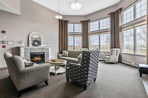 137-1 Crystal Green Lane, Okotoks, AB - Indoor Photo Showing Living Room With Fireplace