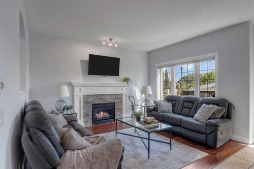 134 Channelside Cove Sw, Airdrie, AB - Indoor Photo Showing Living Room With Fireplace
