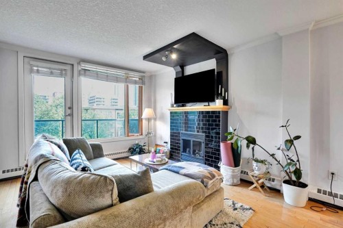 302-1225 15 Avenue Sw, Calgary, AB - Indoor Photo Showing Living Room With Fireplace