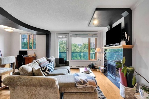 302-1225 15 Avenue Sw, Calgary, AB - Indoor Photo Showing Living Room With Fireplace