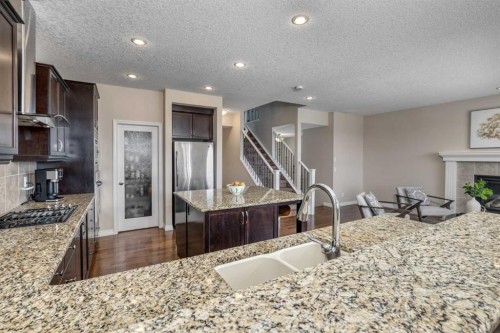 128 Sunset Park, Cochrane, AB - Indoor Photo Showing Kitchen With Double Sink With Upgraded Kitchen