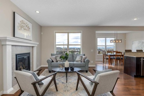 128 Sunset Park, Cochrane, AB - Indoor Photo Showing Living Room With Fireplace