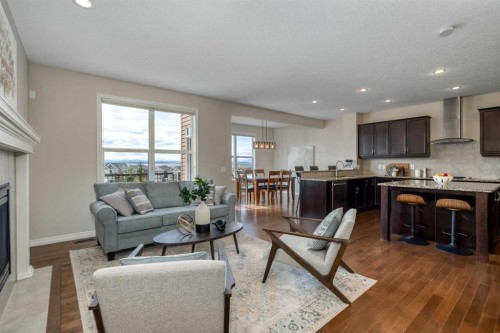 128 Sunset Park, Cochrane, AB - Indoor Photo Showing Living Room With Fireplace
