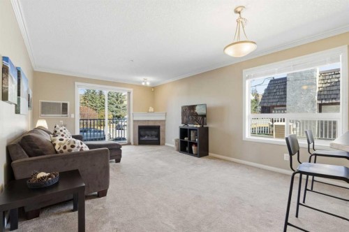 103-128 Centre Avenue, Cochrane, AB - Indoor Photo Showing Living Room With Fireplace
