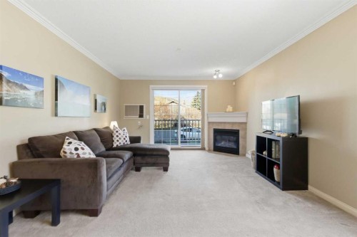 103-128 Centre Avenue, Cochrane, AB - Indoor Photo Showing Living Room With Fireplace