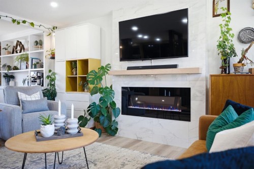 180 Huntford Road Ne, Calgary, AB - Indoor Photo Showing Living Room With Fireplace