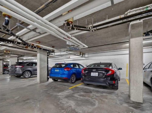 201-72 Quigley Drive, Cochrane, AB - Indoor Photo Showing Garage