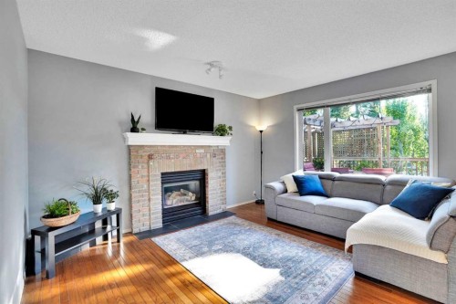 11 Mckenzie Lake View Se, Calgary, AB - Indoor Photo Showing Living Room With Fireplace