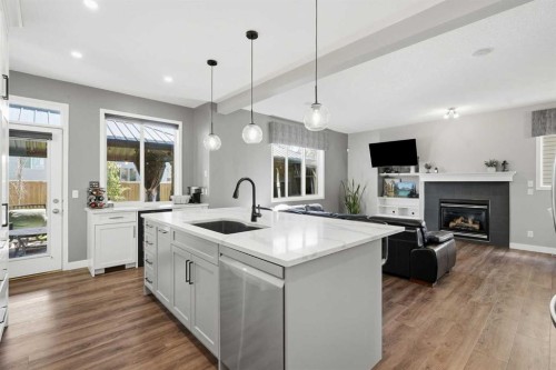 379 Cimarron Boulevard, Okotoks, AB - Indoor Photo Showing Kitchen With Fireplace With Upgraded Kitchen