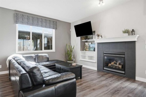 379 Cimarron Boulevard, Okotoks, AB - Indoor Photo Showing Living Room With Fireplace