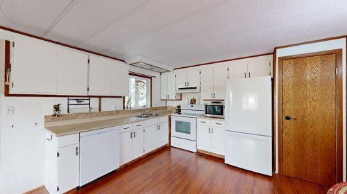 304 Slade Drive, Nanton, AB - Indoor Photo Showing Kitchen With Double Sink