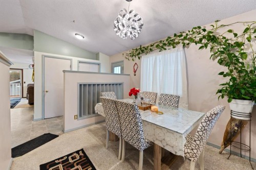3722 Catalina Boulevard, Calgary, AB - Indoor Photo Showing Dining Room With Fireplace