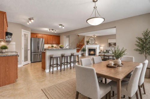 249 Springmere Way, Chestermere, AB - Indoor Photo Showing Dining Room With Fireplace