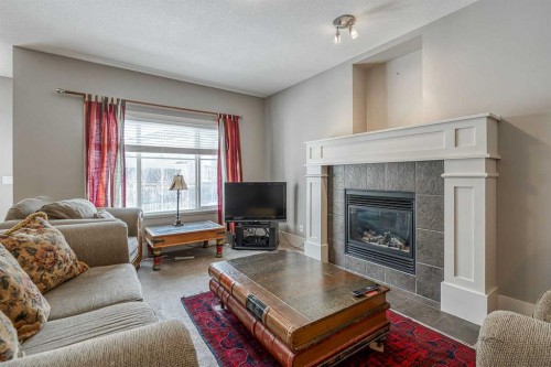 177 Cougartown Circle Sw, Calgary, AB - Indoor Photo Showing Living Room With Fireplace