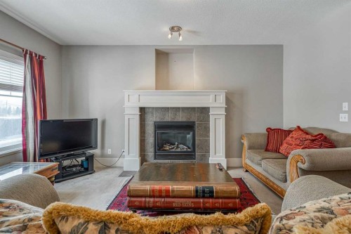 177 Cougartown Circle Sw, Calgary, AB - Indoor Photo Showing Living Room With Fireplace