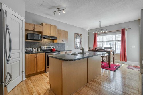 177 Cougartown Circle Sw, Calgary, AB - Indoor Photo Showing Kitchen With Double Sink