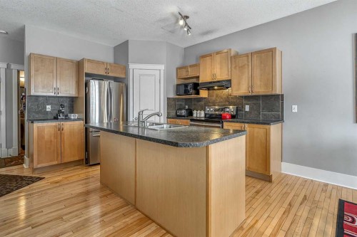 177 Cougartown Circle Sw, Calgary, AB - Indoor Photo Showing Kitchen With Double Sink