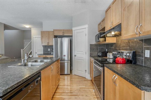 177 Cougartown Circle Sw, Calgary, AB - Indoor Photo Showing Kitchen With Double Sink