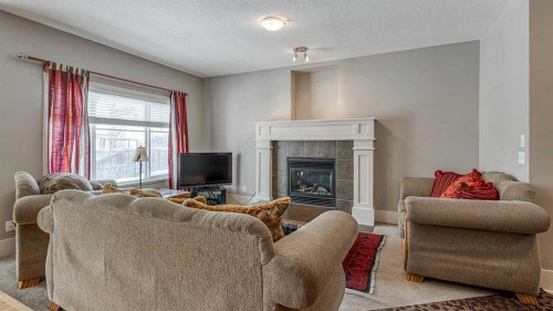 177 Cougartown Circle Sw, Calgary, AB - Indoor Photo Showing Living Room With Fireplace