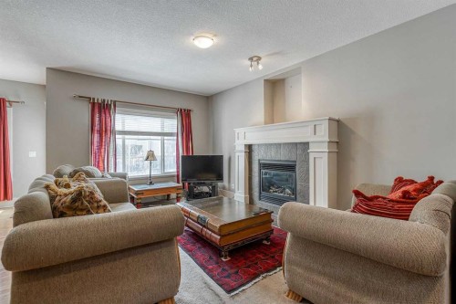 177 Cougartown Circle Sw, Calgary, AB - Indoor Photo Showing Living Room With Fireplace