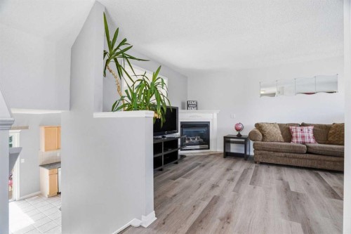 62 Country Hills Cove Nw, Calgary, AB - Indoor Photo Showing Living Room With Fireplace