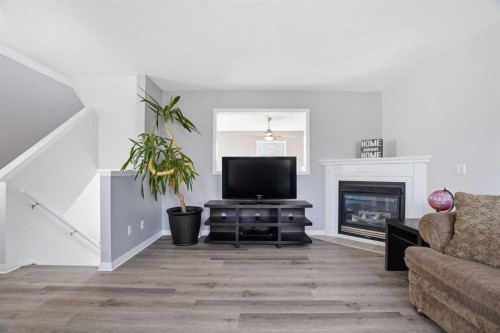 62 Country Hills Cove Nw, Calgary, AB - Indoor Photo Showing Living Room With Fireplace