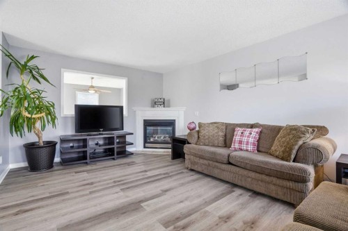 62 Country Hills Cove Nw, Calgary, AB - Indoor Photo Showing Living Room With Fireplace