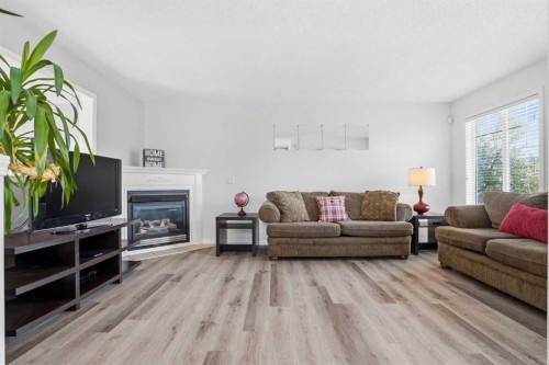 62 Country Hills Cove Nw, Calgary, AB - Indoor Photo Showing Living Room With Fireplace